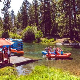 a group of people on a raft in a wooded area