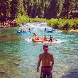 a group of people standing next to a body of water