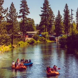 a group of people in a small boat in a body of water