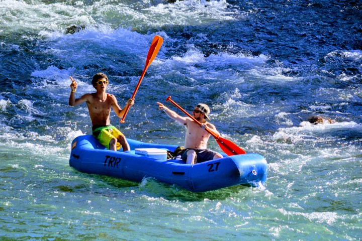 Two friends braving the rapids aboard a raft