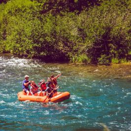 a group of people on a raft in a body of water